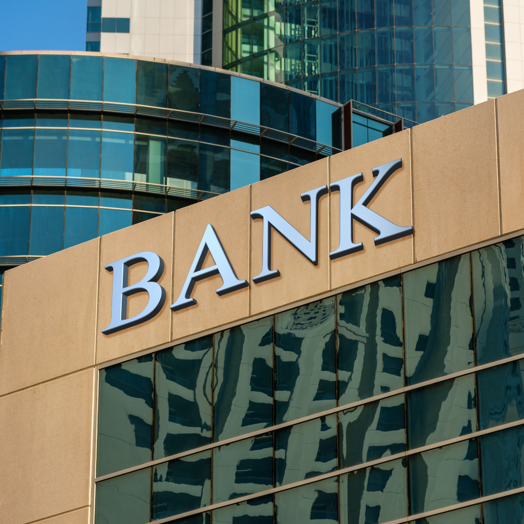 silver bank sign on green and gold building